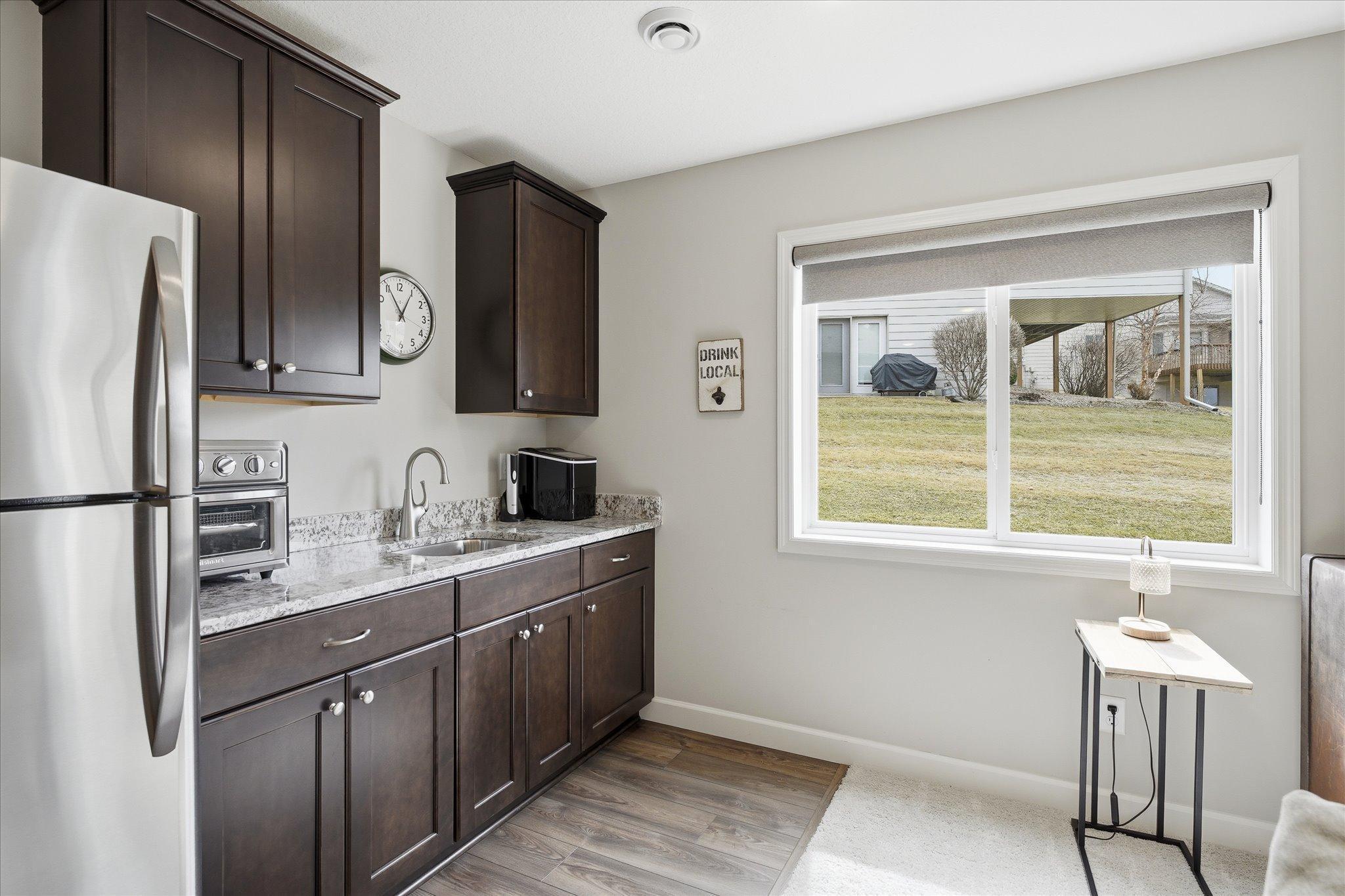 Family room wet bar with full refrigerator and wine frig. Game changer!