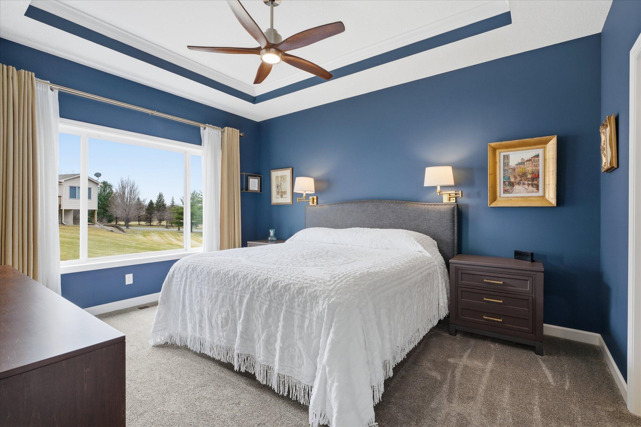 The primary suite has a dramatic and warm feel. Dramatic ceiling feature. A must see to experience the ambiance.