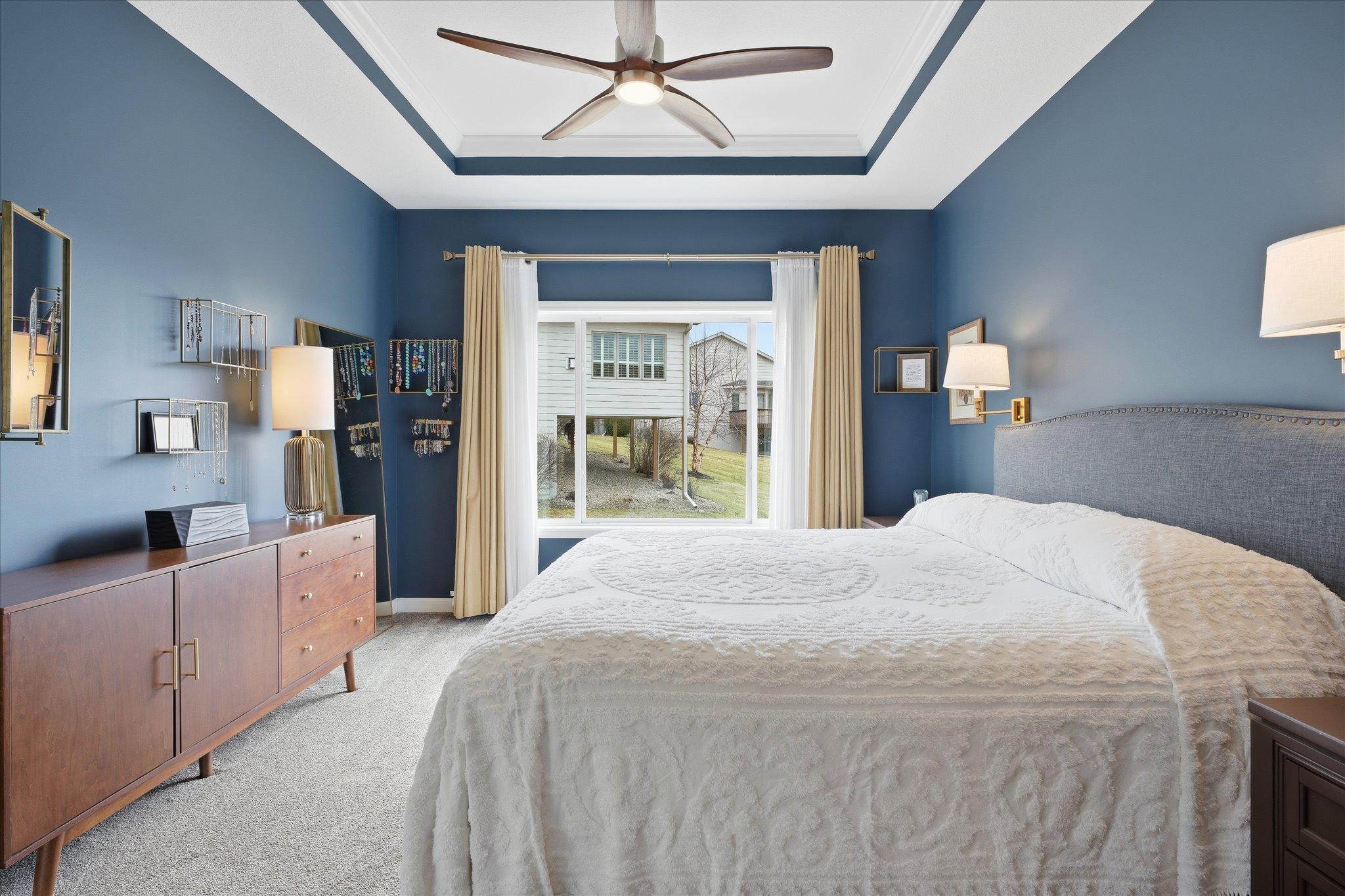 The primary suite has a dramatic and warm feel. Dramatic ceiling feature. A must see to experience the ambiance.