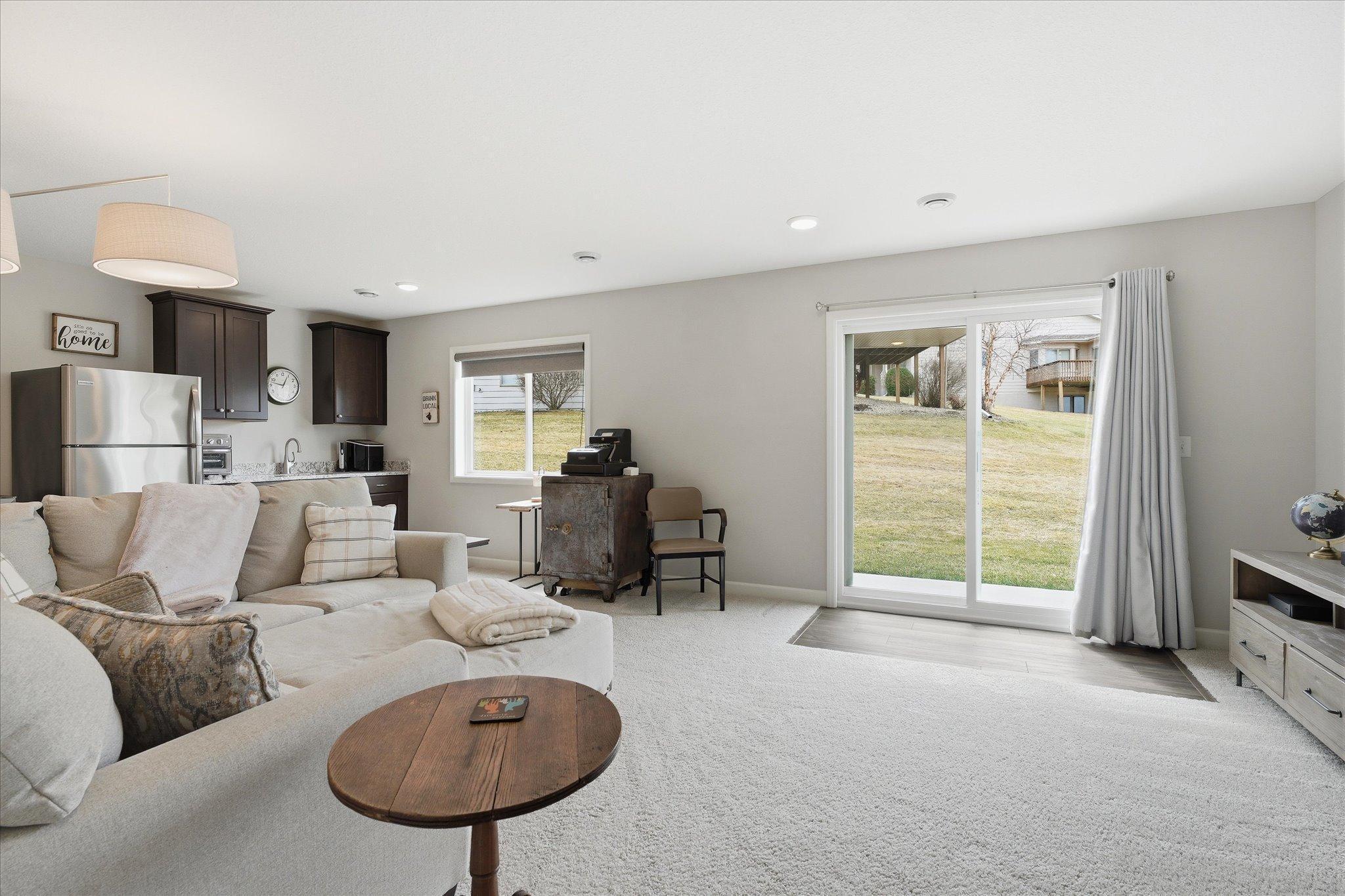 Lovely lower level family room with wet bar. Leave all the blinds and curtains open to let in the sun, or close it up for a great movie night!