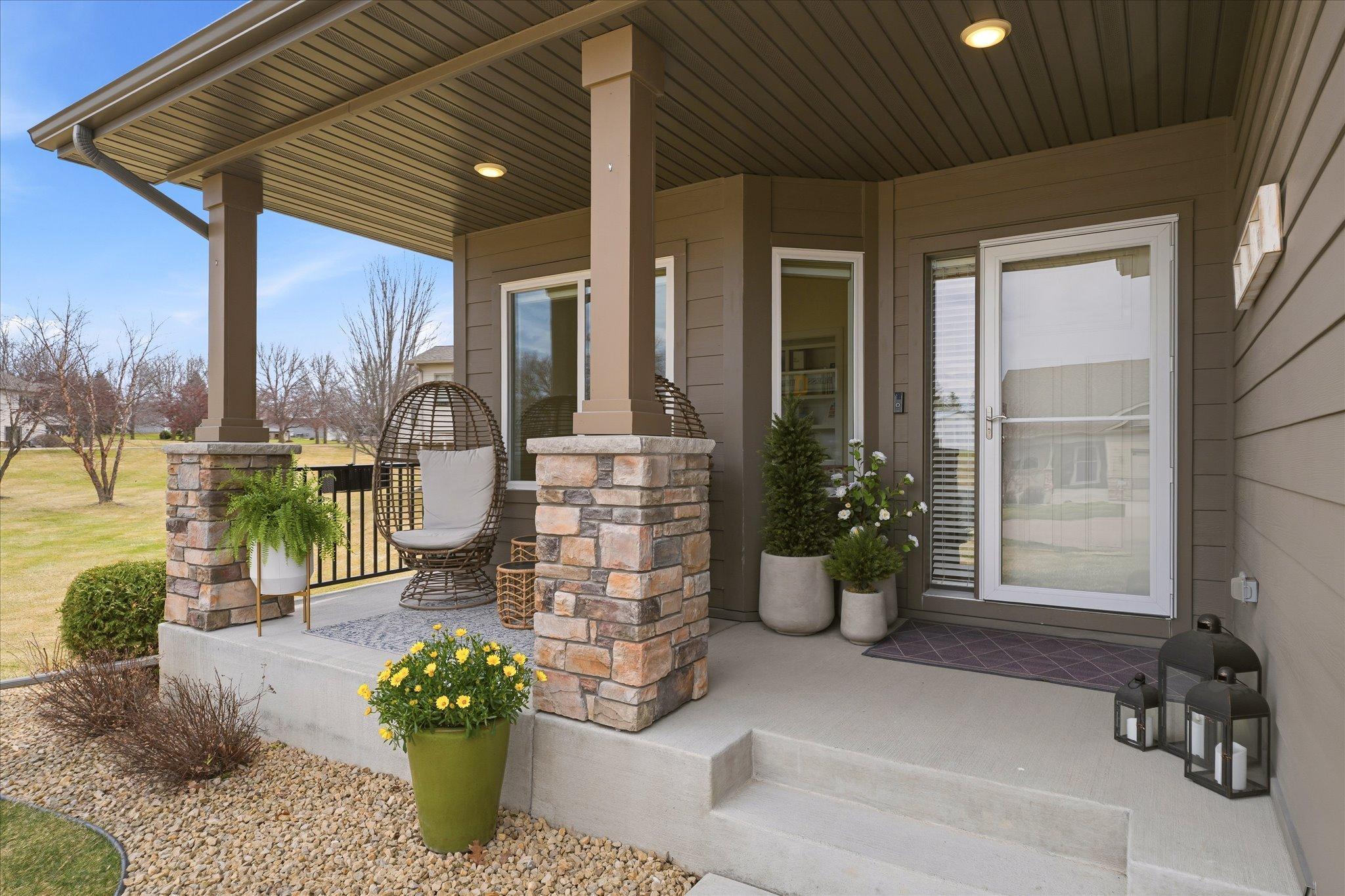 Greet your guests on your covered front porch! Even a couple extra parking spots off to the side by the community garden.