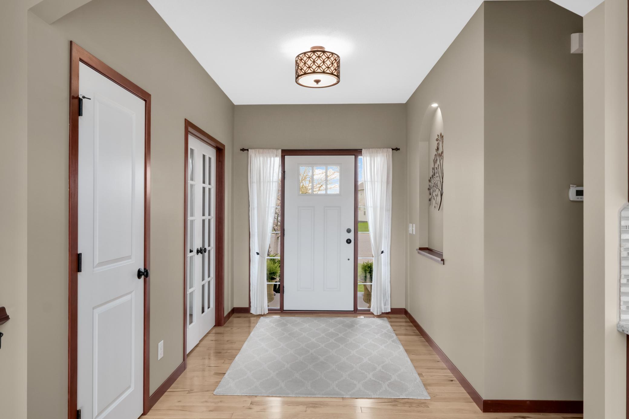 You’ll appreciate the fine craftsmanship throughout, highlighted by decorative wall niches, arched entryways, and glass double doors.