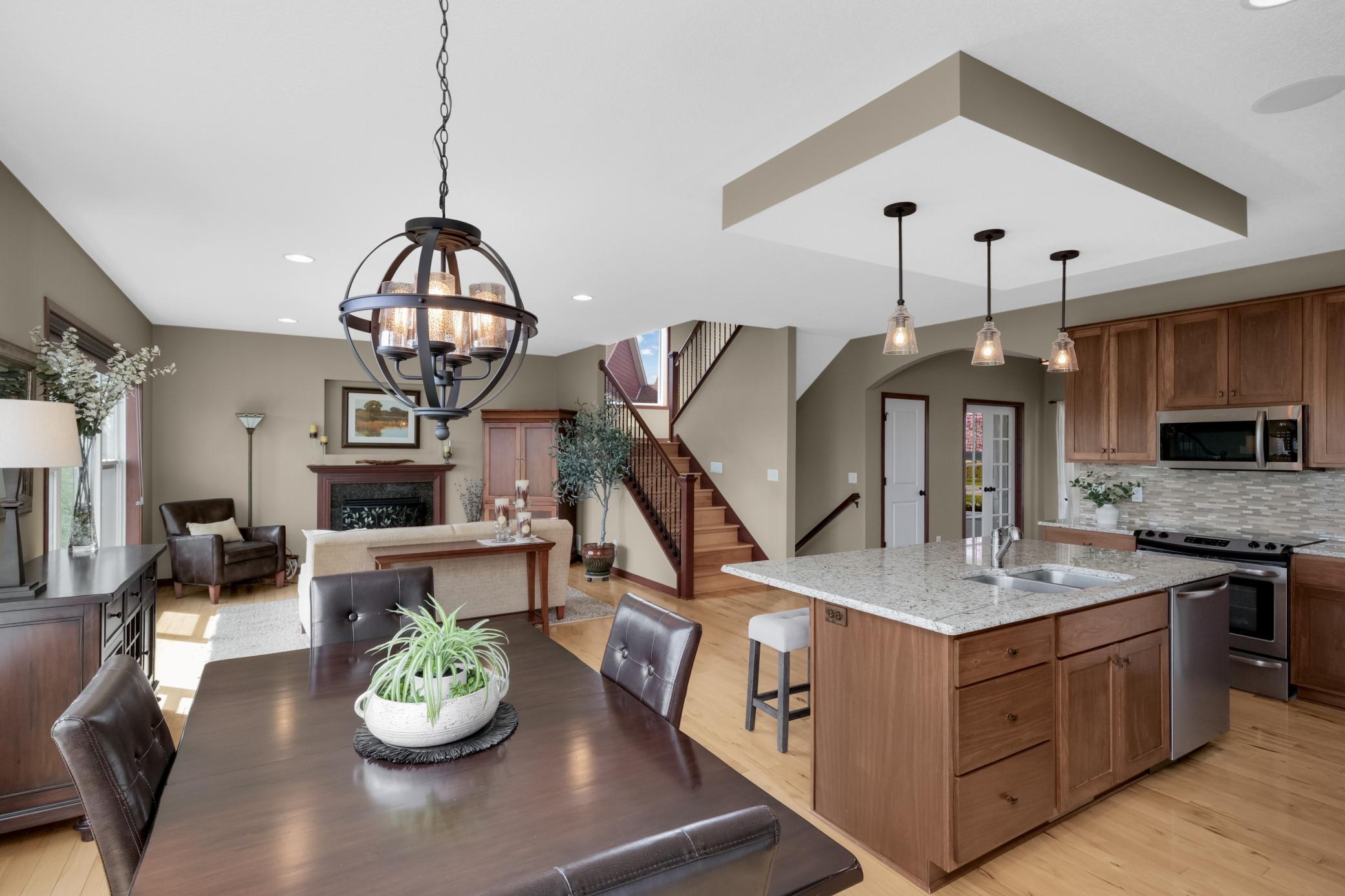 The timeless stairwell stands out with its decorative open spindles and warm wood floors.
