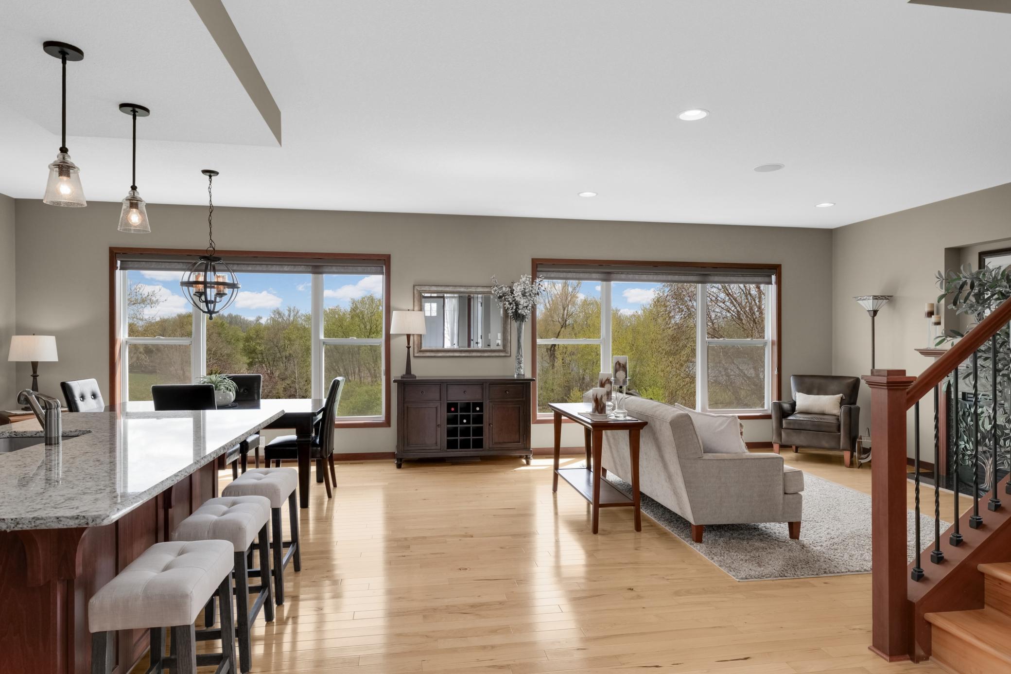 Bright open-concept main floor living space featuring premium windows that frame serene, tranquil views.