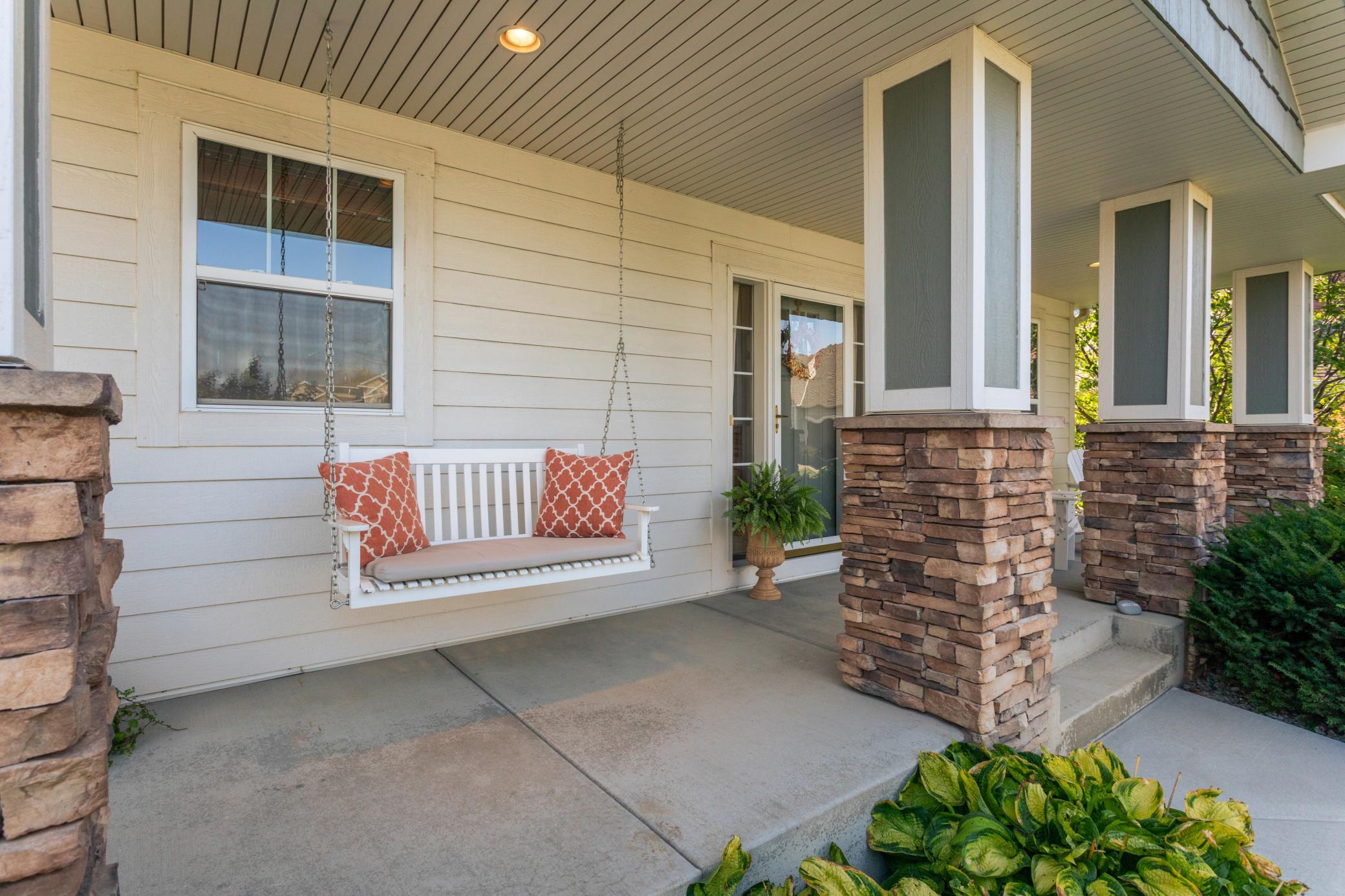 Timeless exterior design featuring durable hardboard siding with rich stone accents.