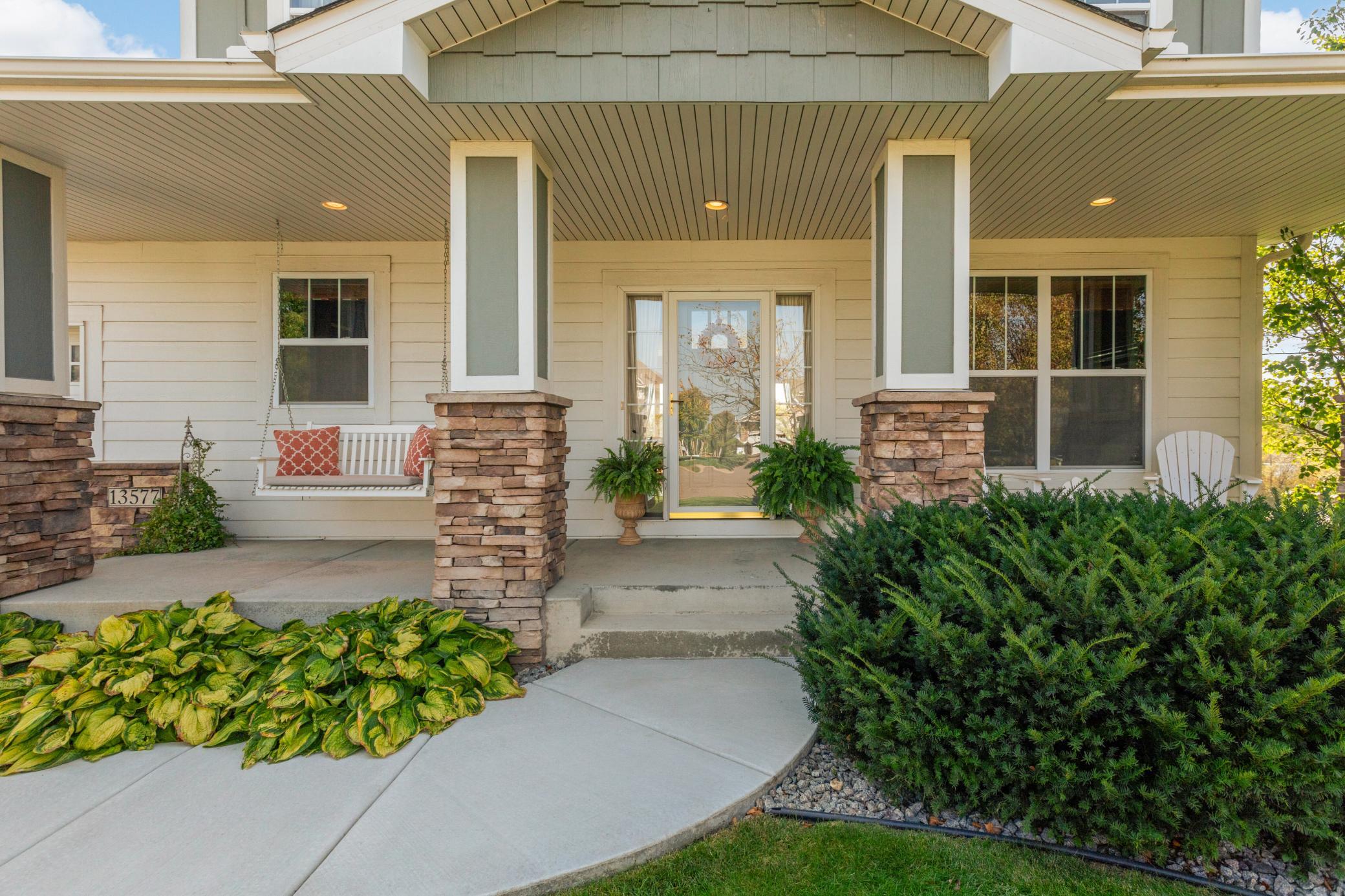 Enjoy quiet mornings and evening sunsets from the inviting front porch complemented by a new concrete walkway.