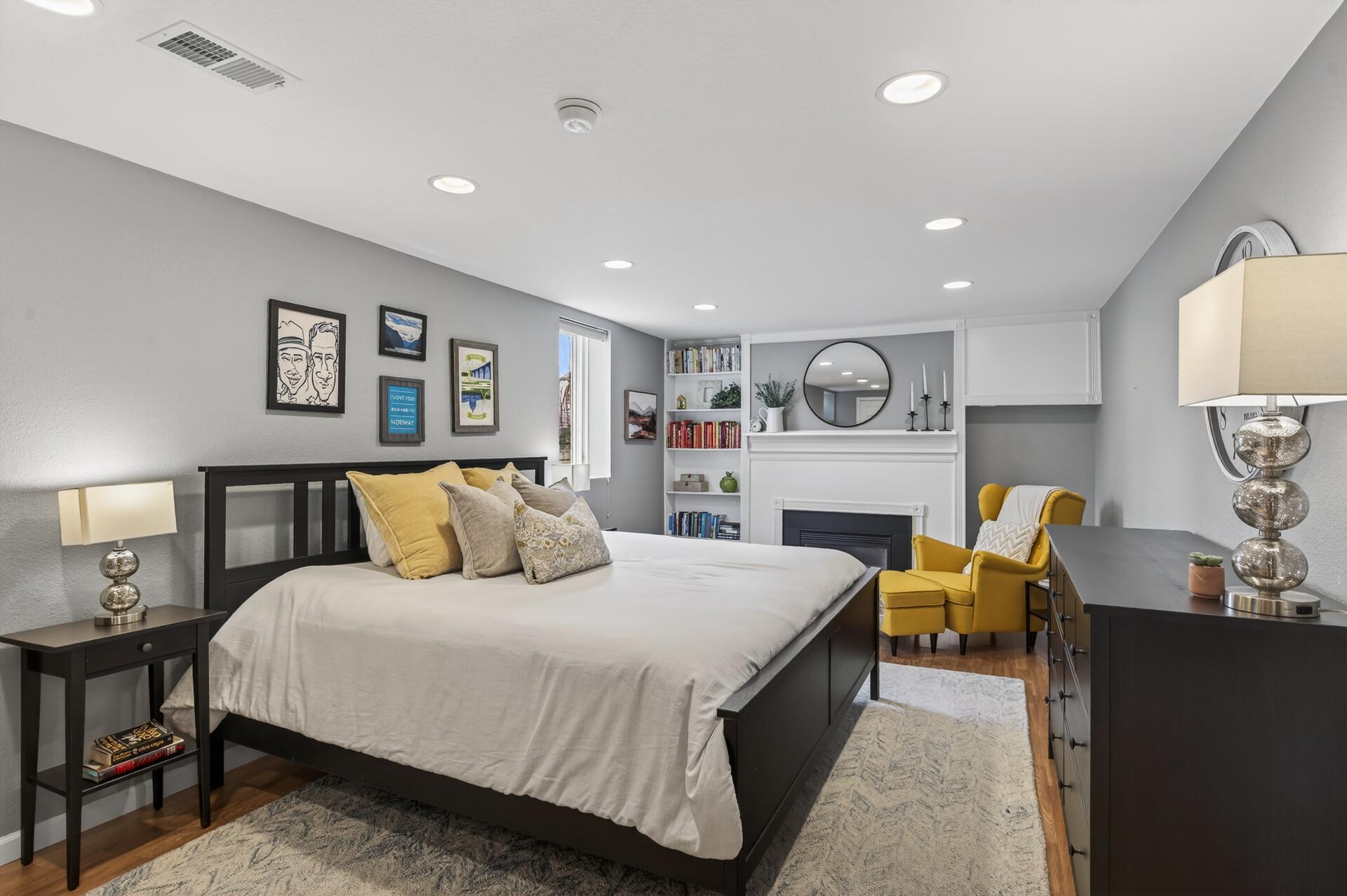 Primary bedroom with ensuite full bathroom and gas fireplace