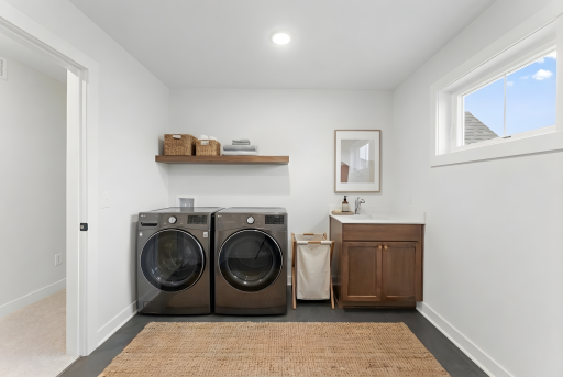 Upper level laundry room connected to primary closet *Photo of similar home