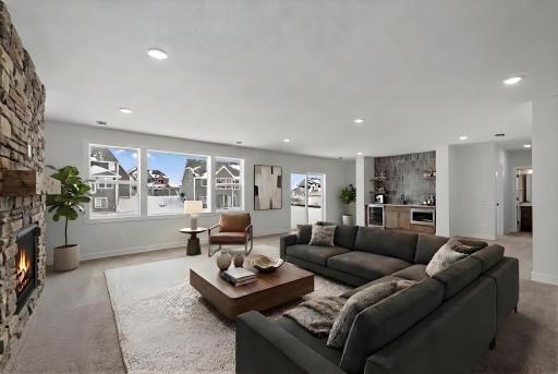 Lower level family room with gas fireplace and wet bar *Photo of similar home and virtually staged