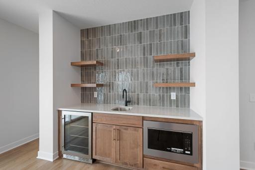 Lower level wet bar *Photo of similar home