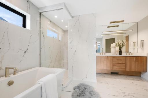 Primary ensuite with walk-in tile shower, freestanding soaker tub and dual vanities *Photo of similar home