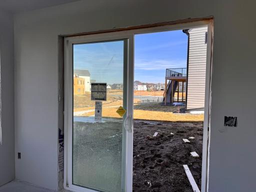 View of the backyard out the lower level sunroom and to the right