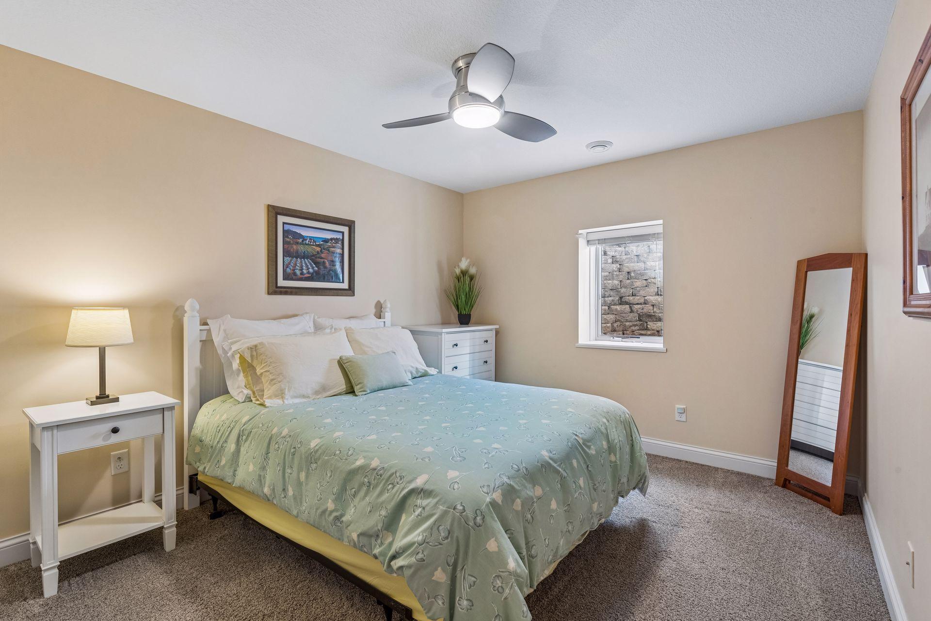 Lower-level bedroom #3 with egress window. 14'5"X10'8"
The mattress is a queen size.