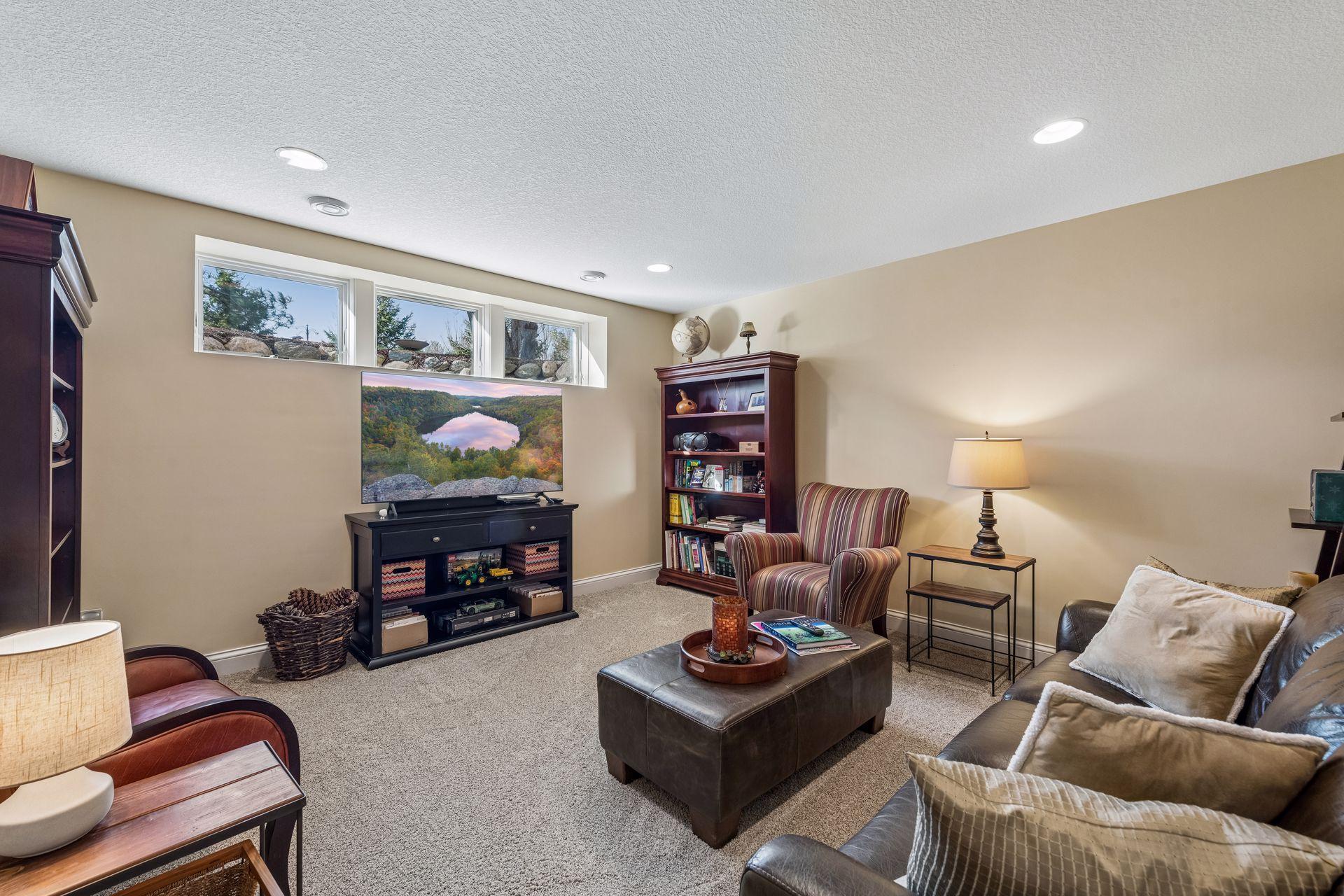 Lower-level family room is 13'5'X13'5'. The three windows bring in lots of morning light. Ceiling is 8 ft. tall.