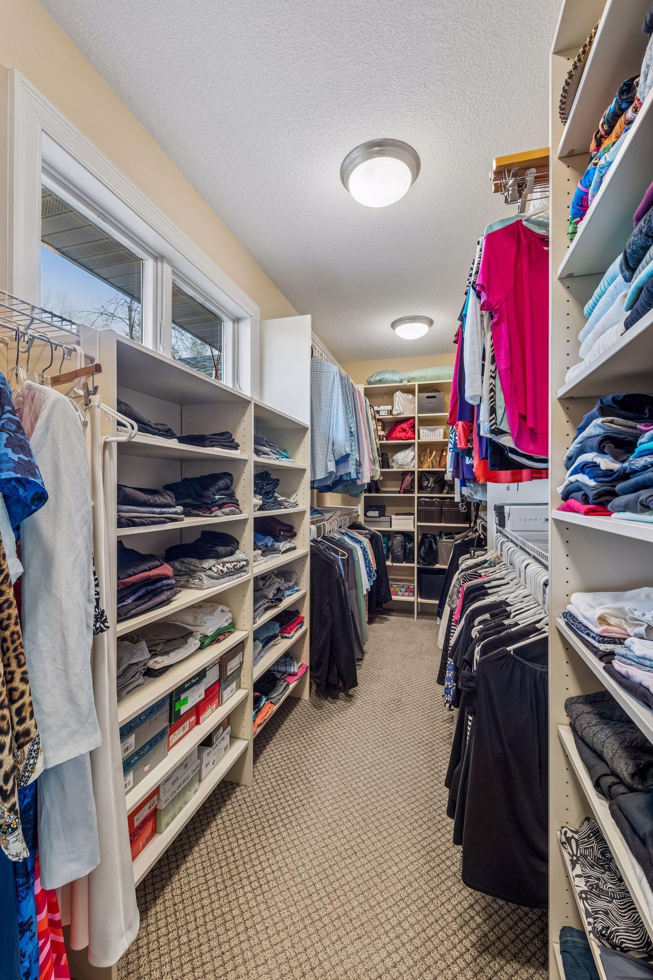 Main level, en-suite, oversized walk-in closet. 18' 8"X 9' 5" The windows add natural light to this closet.