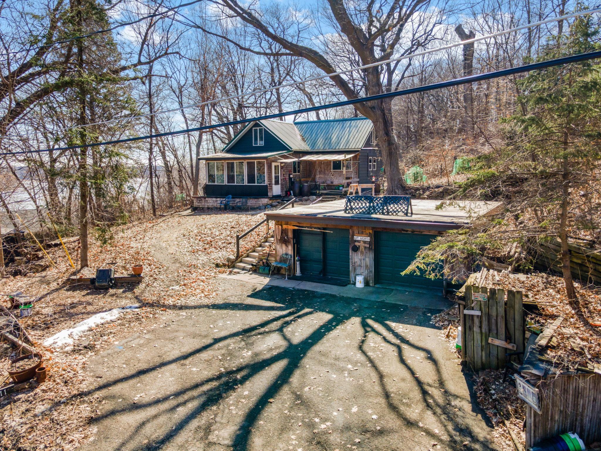 Sloped .52 acre lot, steps from the neighborhood fishing dock and trail leading to the swimming beach and picnic/play area