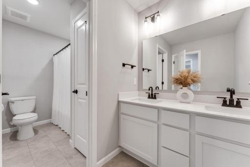 Upper level full bath with dual sinks and separate shower/bath and toilet room