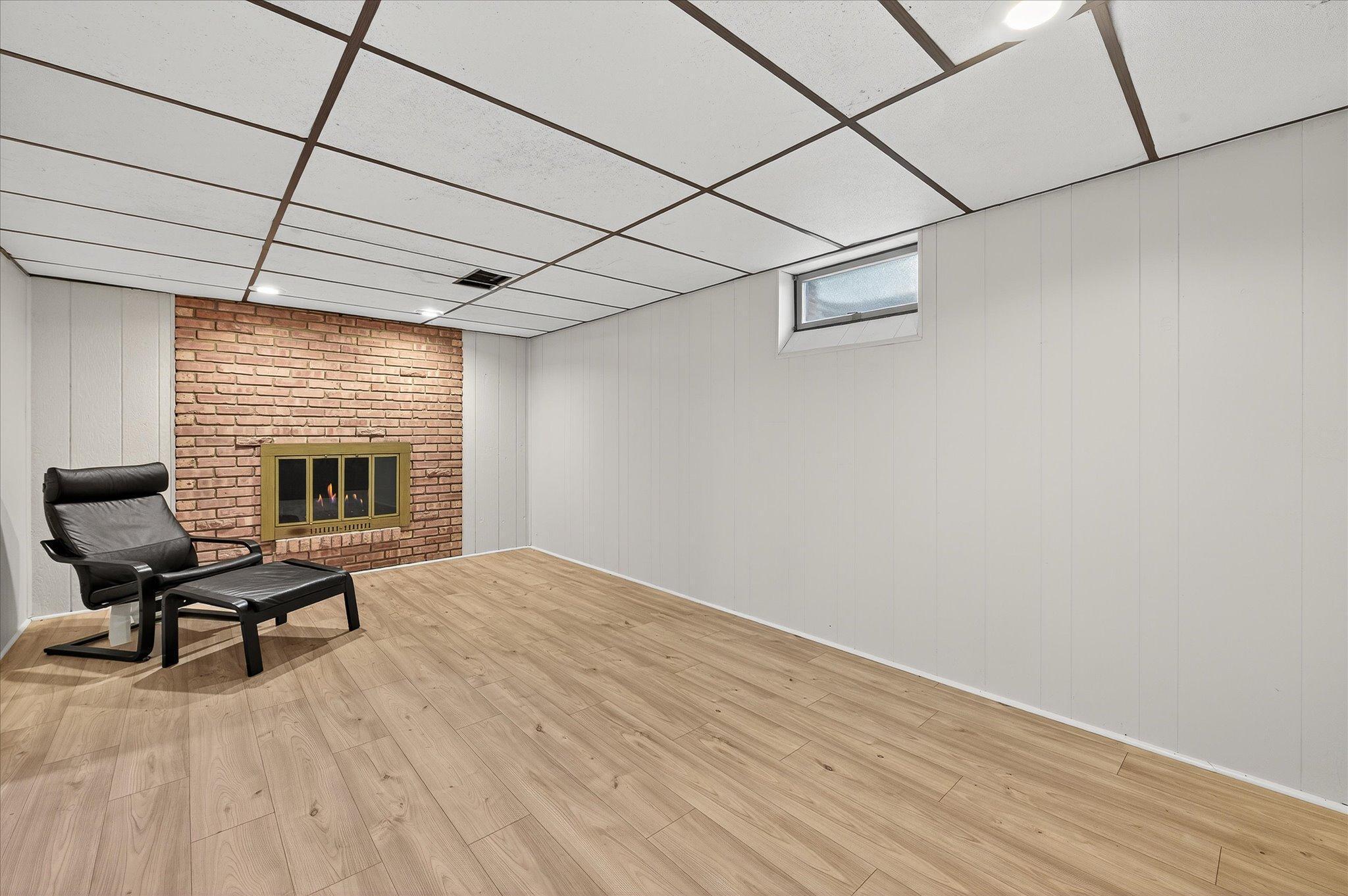 Family Room in the Lower Level with a Wood Burning Fireplace