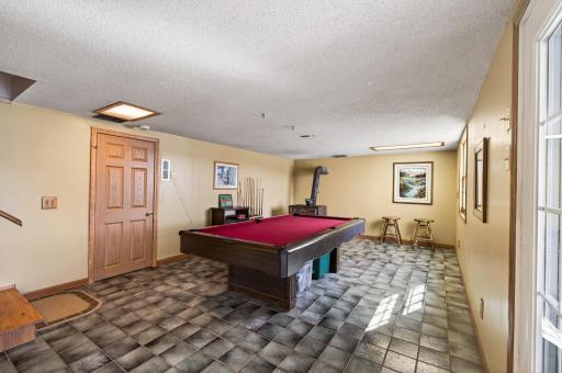 Enormous Rec room in the lower level with views of the lake, easily add carpet or lvt to make it a comfy living space!
