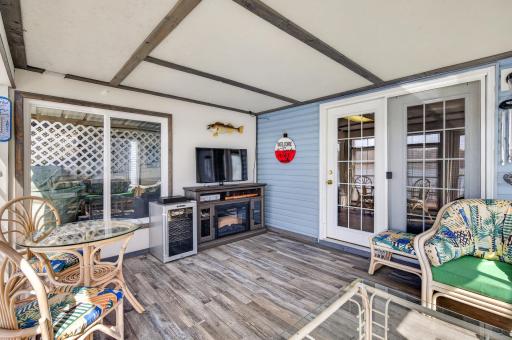 Watch the game or a movie with the lake breeze in your 3 season porch!