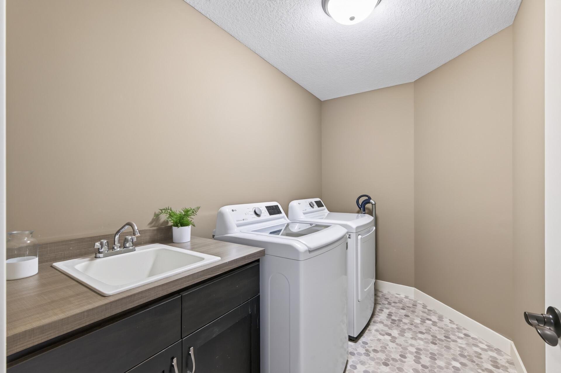 The spacious laundry room keeps everyday chores organized.
