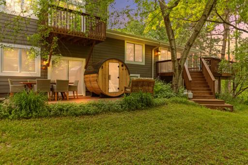 Back of home with patio, deck, sauna, and balcony