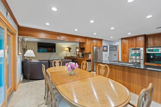 Dining space main floor with access to deck and grill