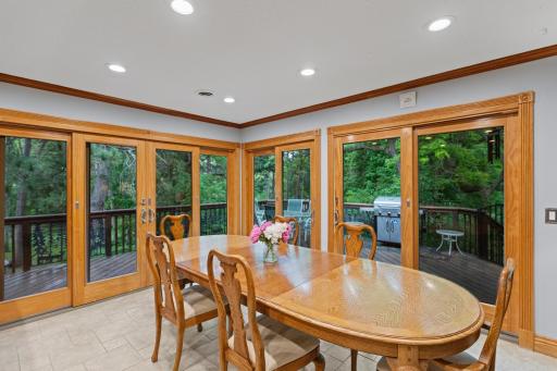 Dining space main floor with access to deck and grill