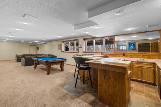 Huge amusement room in lower level with a wet bar