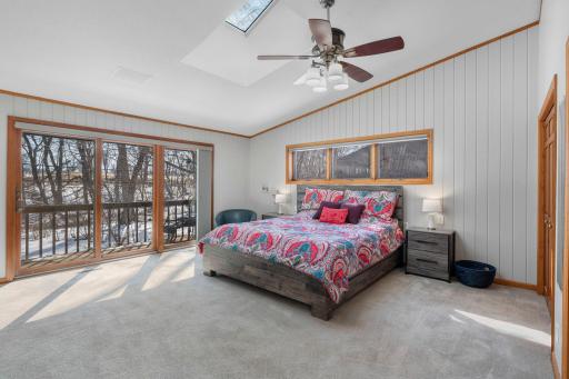 Primary bedroom with sliding glass door to deck