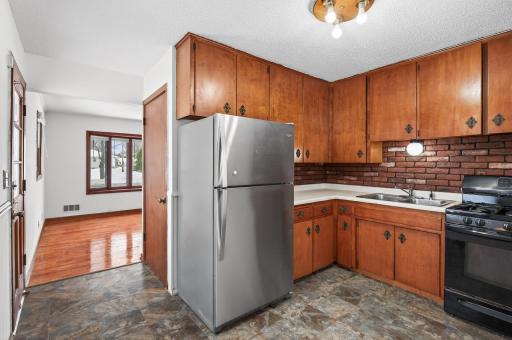 Kitchen with wood cabinetry, stainless steel appliances and gas range