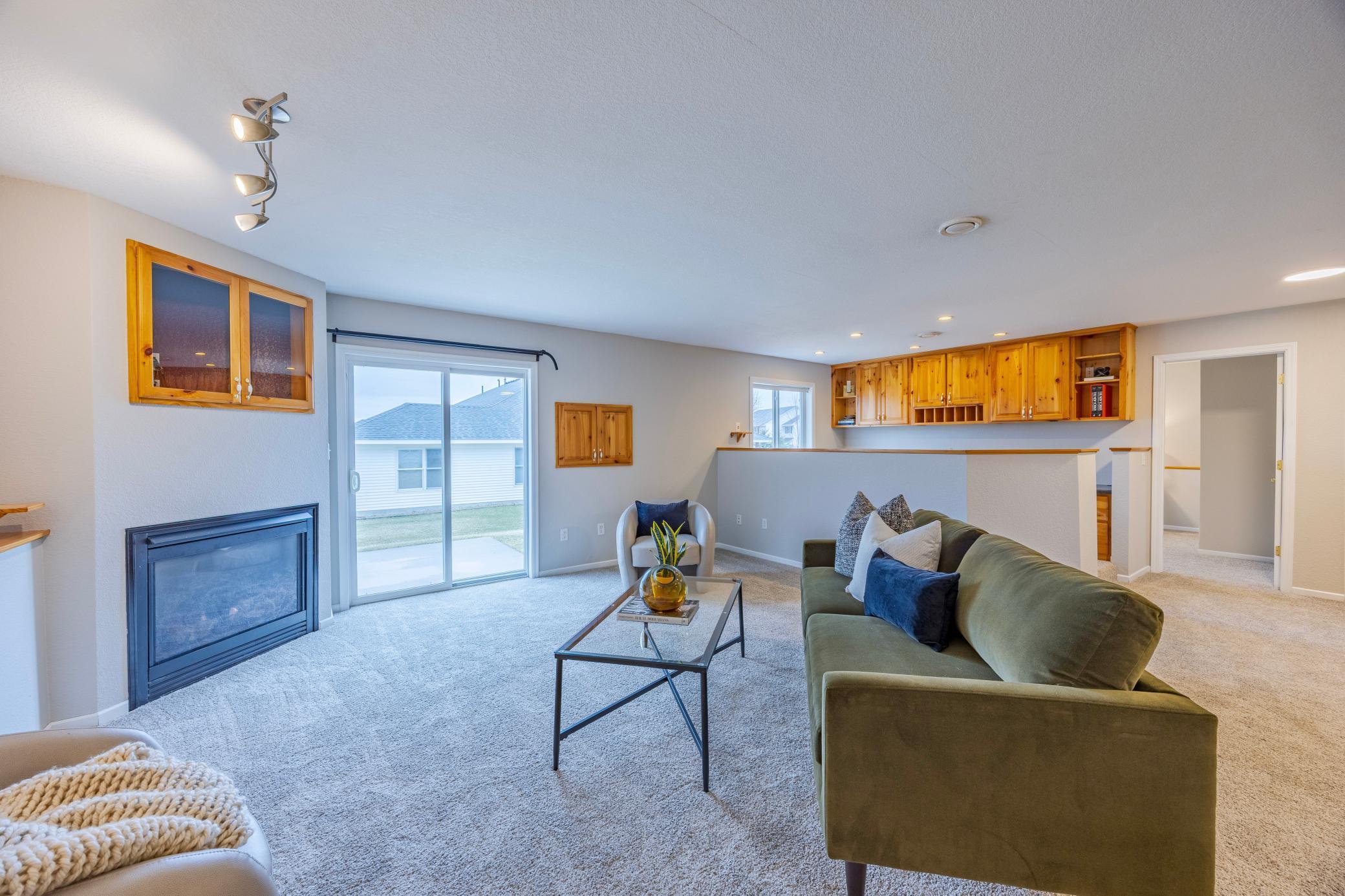 Large built-in desks behind the lower-level living room. Third bedroom door on the back right of photo.