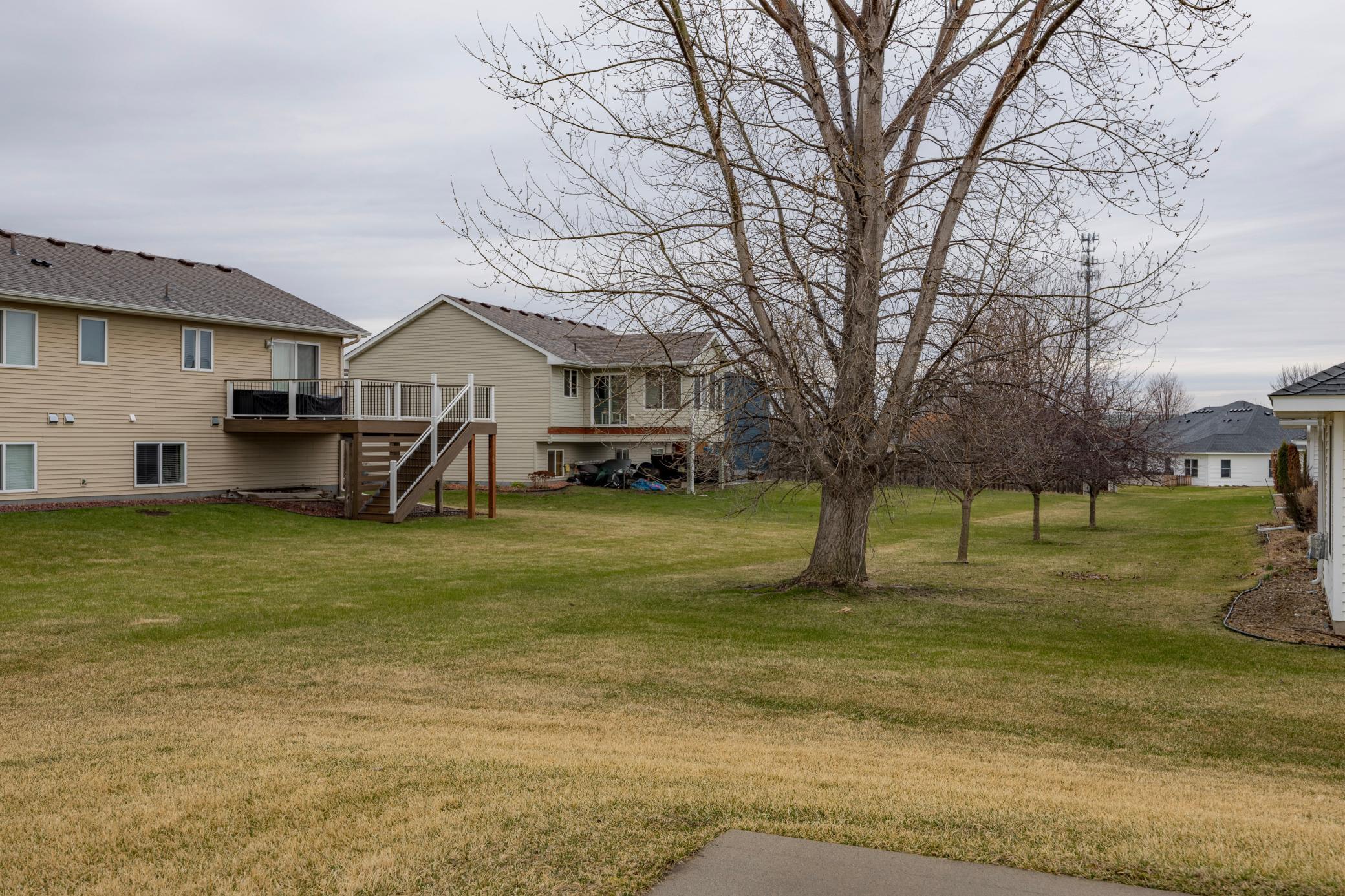 view of homes and yard space you can see from the walkout patio.