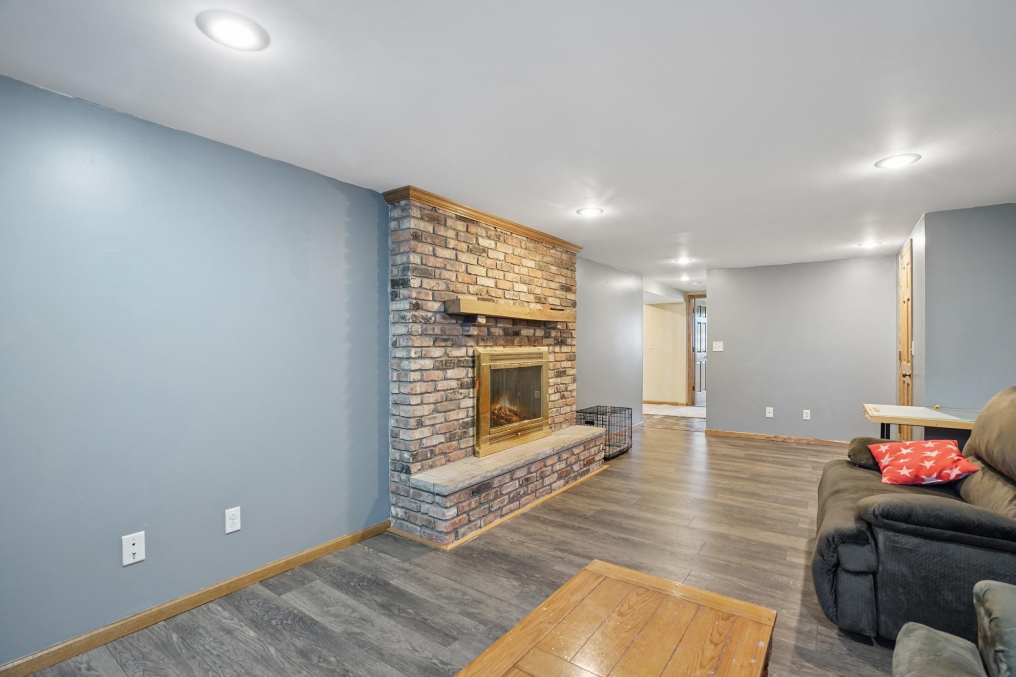 The family room features a gas fireplace with a brick surround. Fireplace has not been used by the sellers.