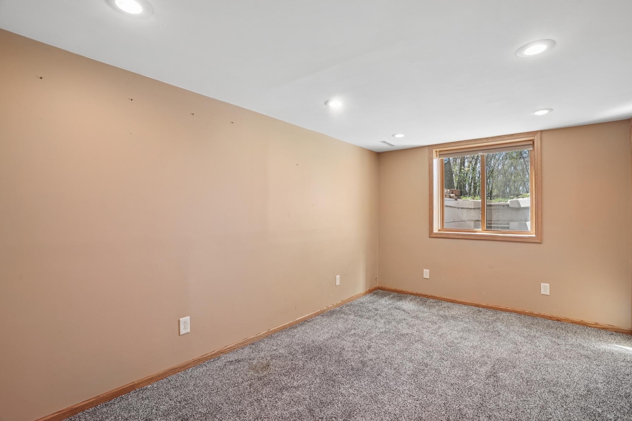 The third bedroom is located in the basement and features an extra large closet with three doors.