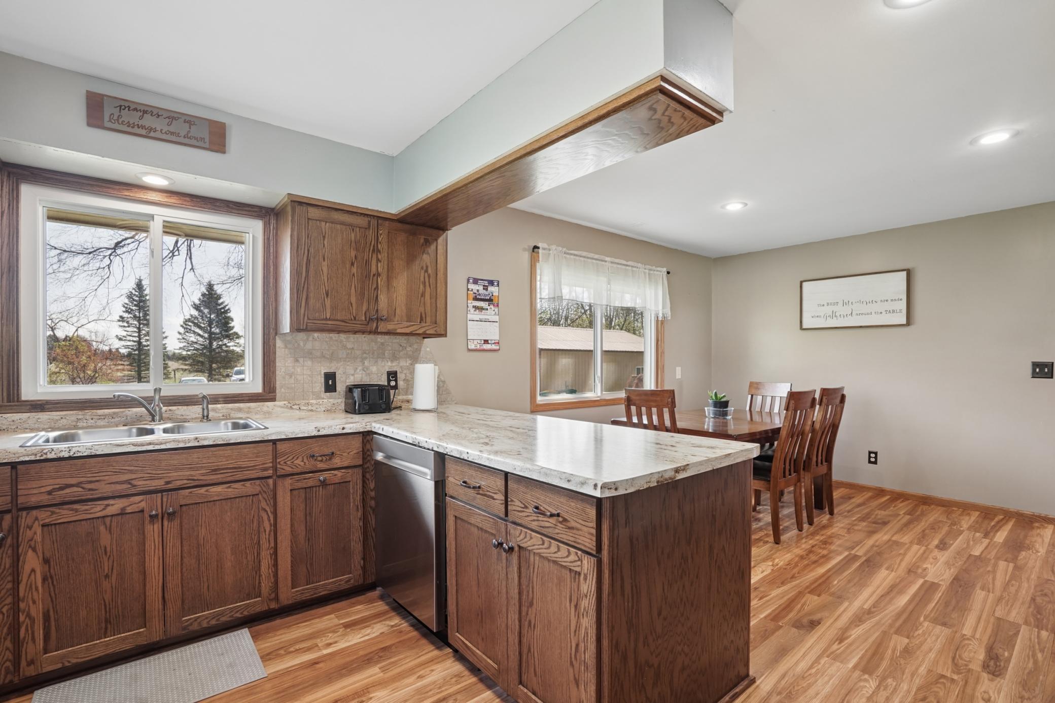 Kitchen features a garbage disposal. A window above the sinks looks out into the front yard.