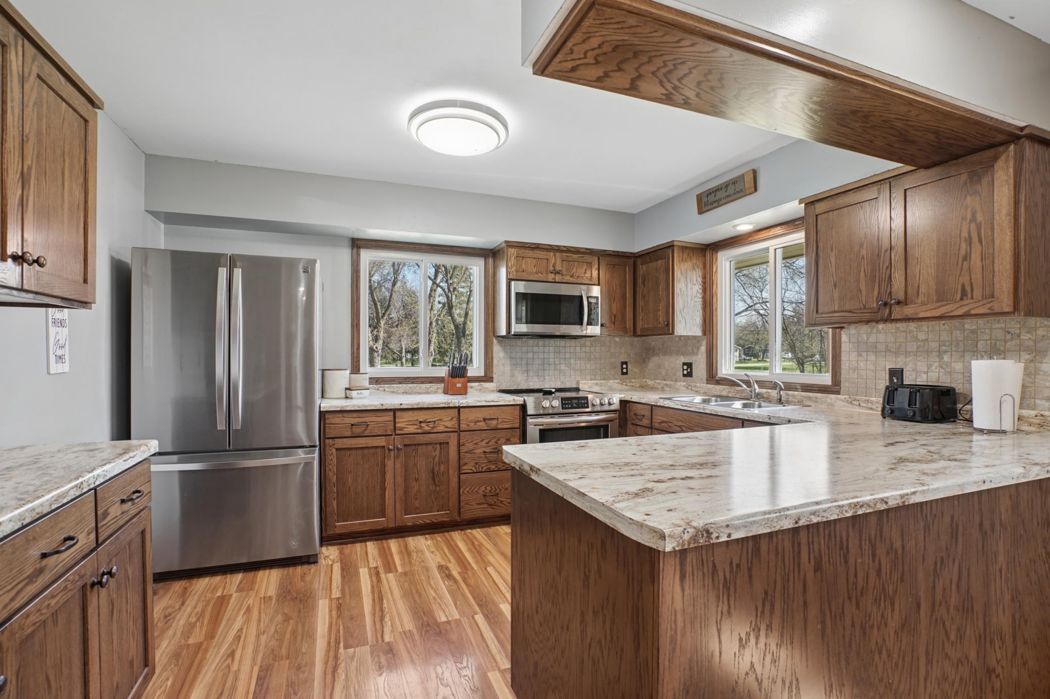 The kitchen has been thoughtfully updated with custom Schlangen cabinets, S.S. appliances, and durable LVP flooring.