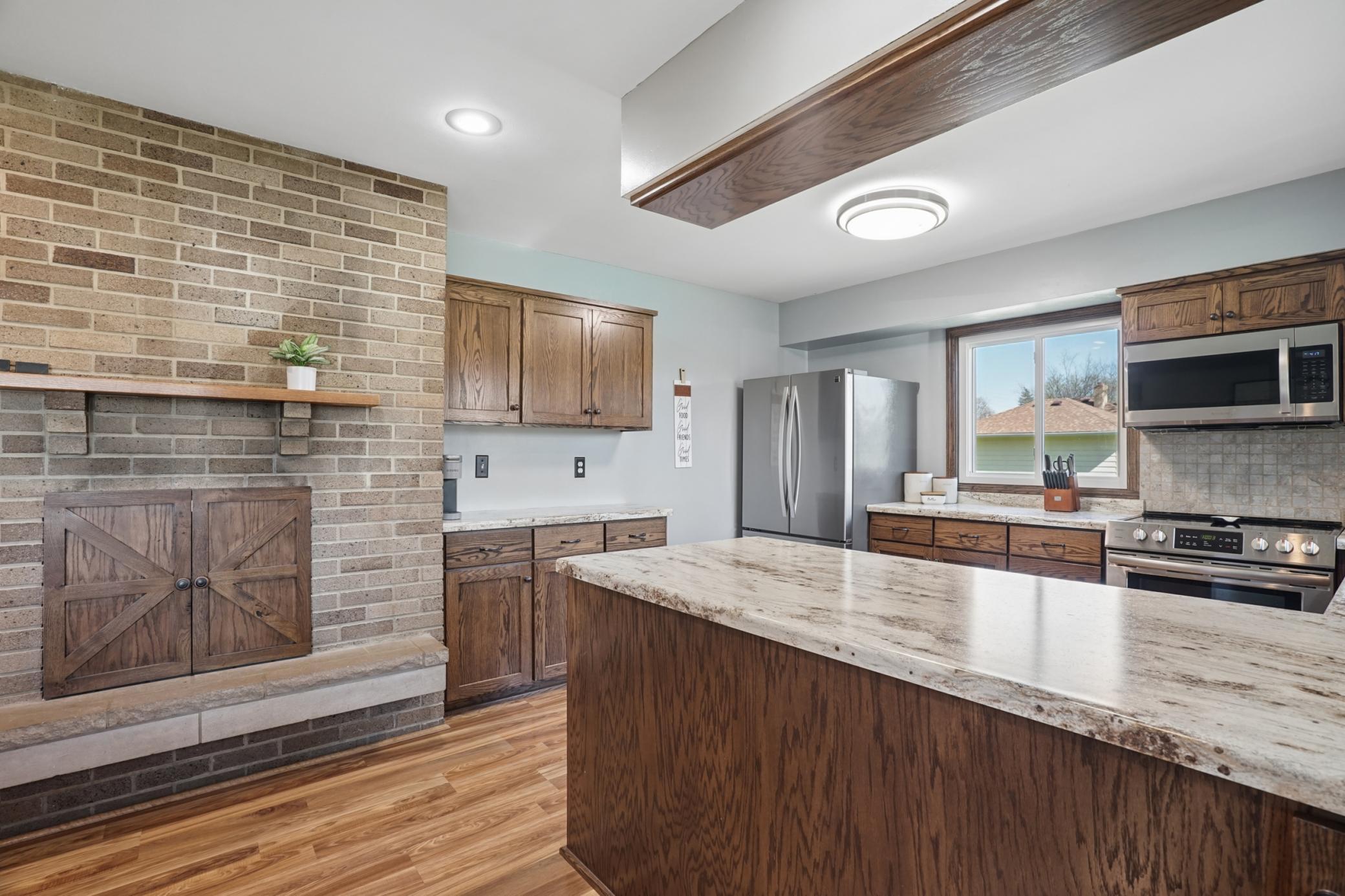 The fireplace is also featured in the kitchen. The fireplace has not been used by the sellers.