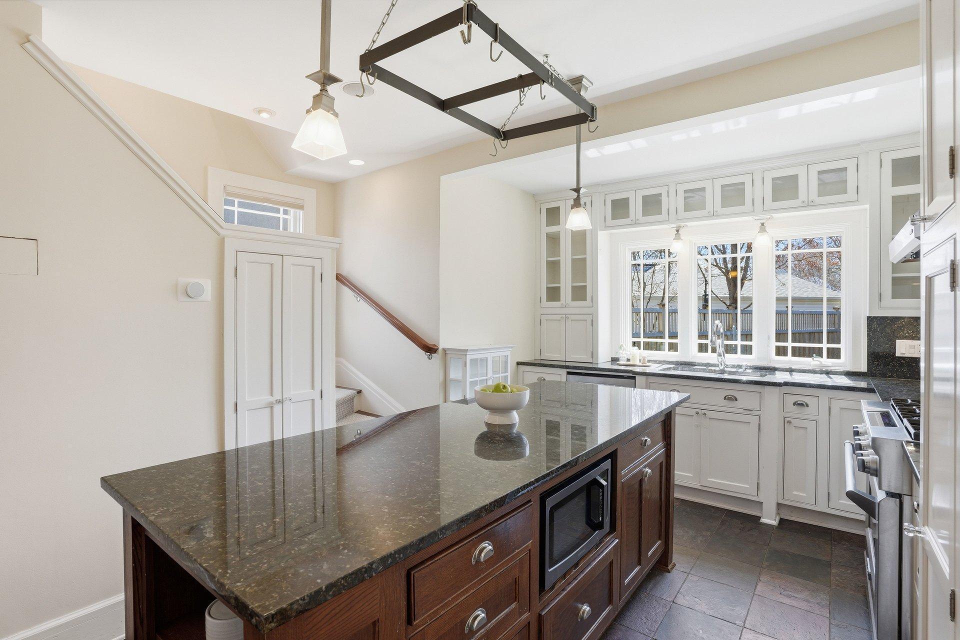 2200 Kenwood Parkway - The windows over the sink offer a full view of the backyard. The large period center island offers additional storage and informal seating.