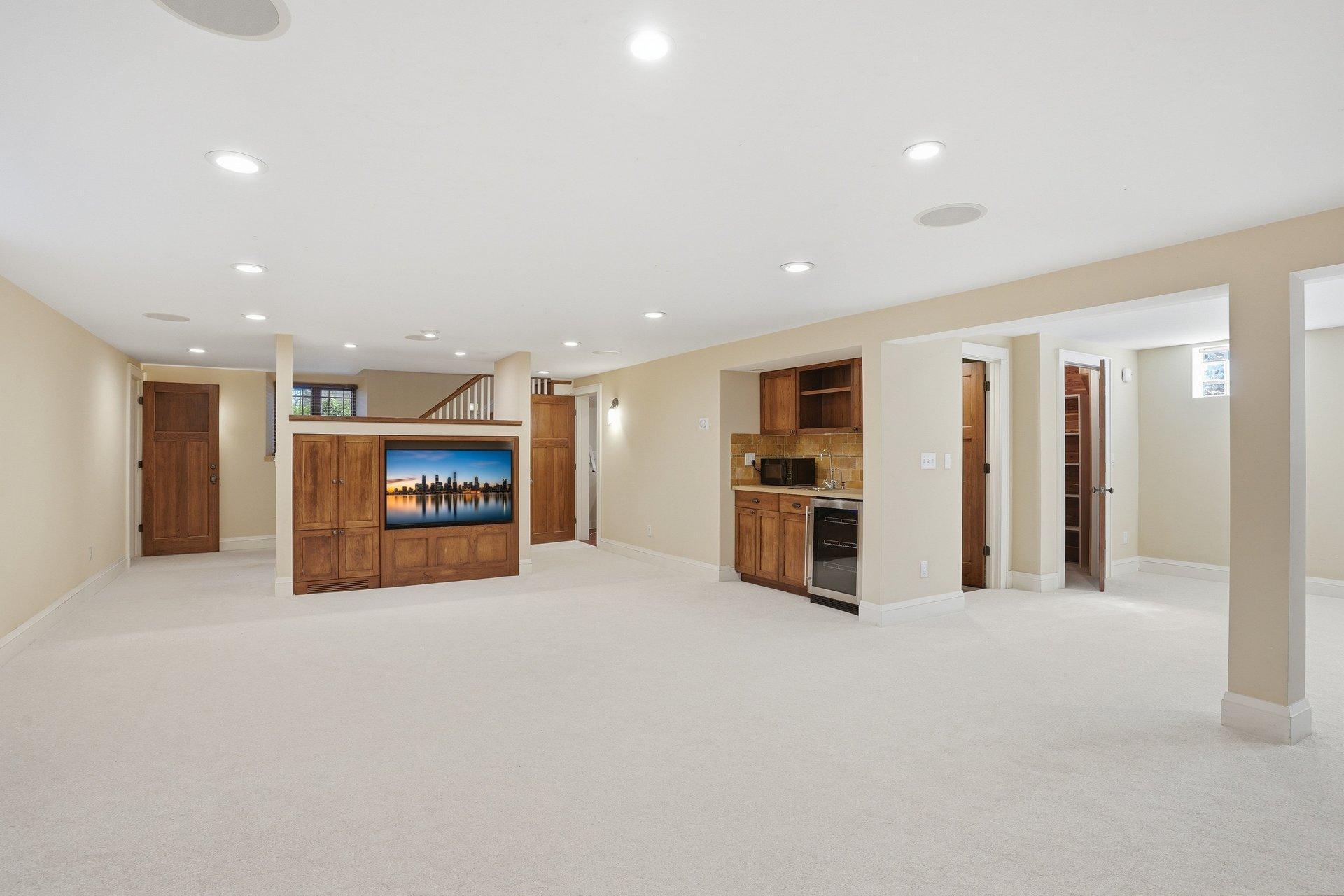 2200 Kenwood Parkway - Lower Level includes built-in entertainment area, as well as a wet bar, fridge, and cabinetry