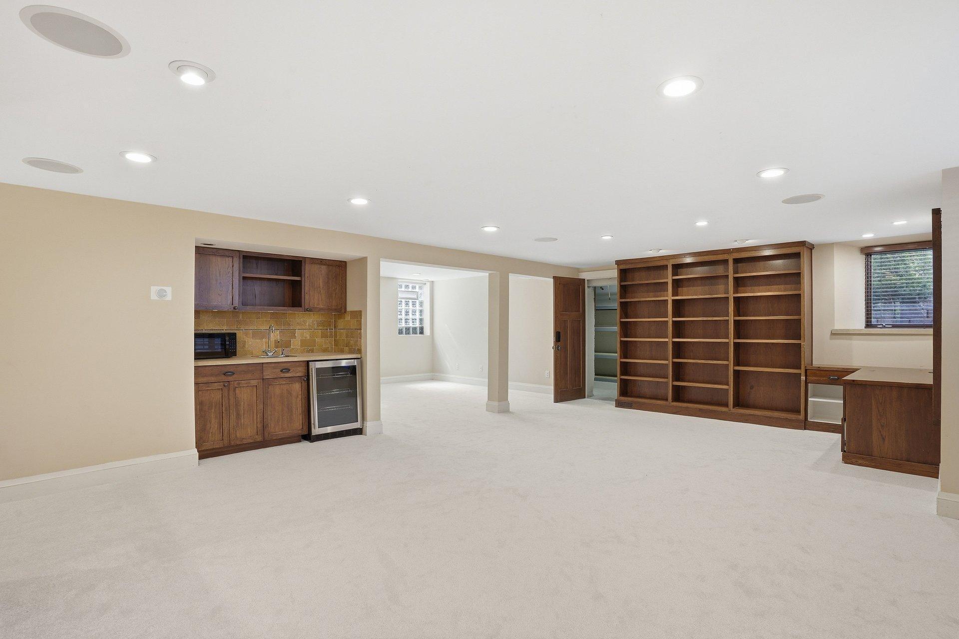 2200 Kenwood Parkway - Family room in Lower Level includes a wet bar with fridge and shelving, as well as built-in book shelves