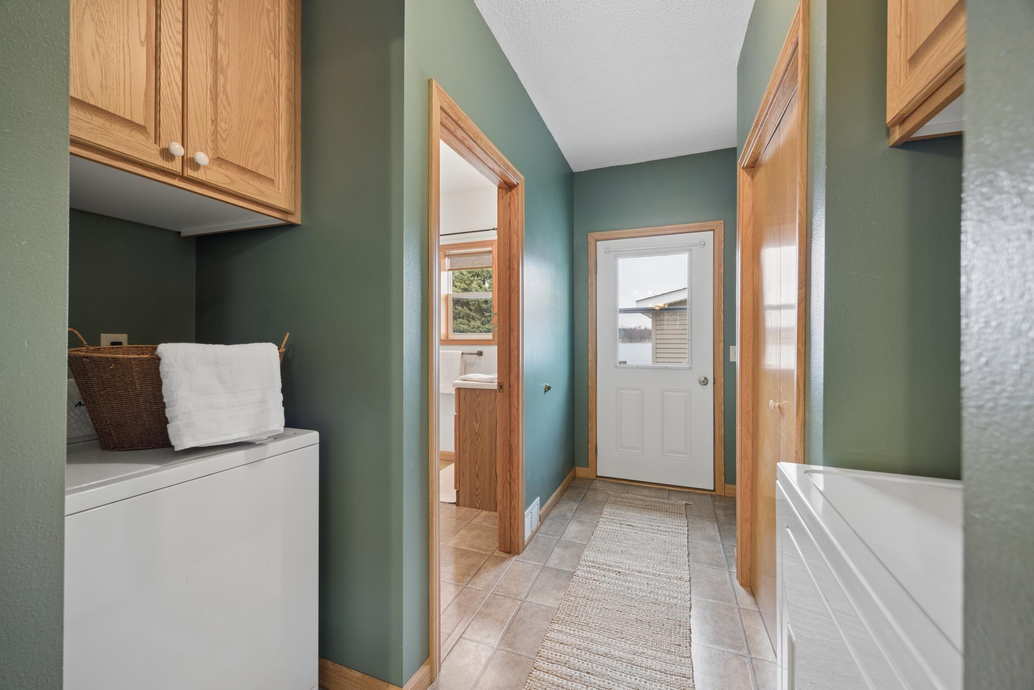 Conveniently placed laundry with tons of storage space.