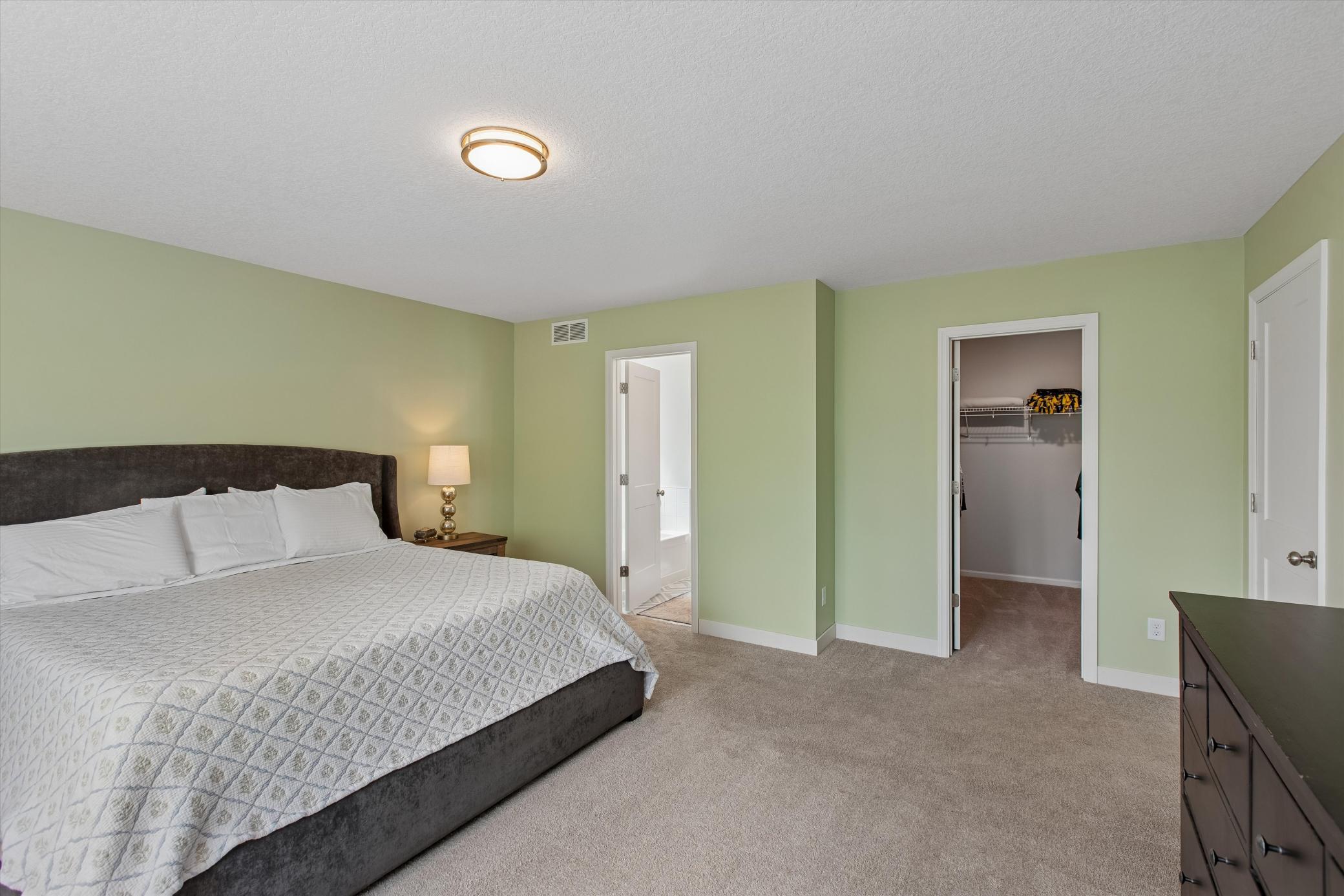 Primary bedroom with walk-in closet and en suite