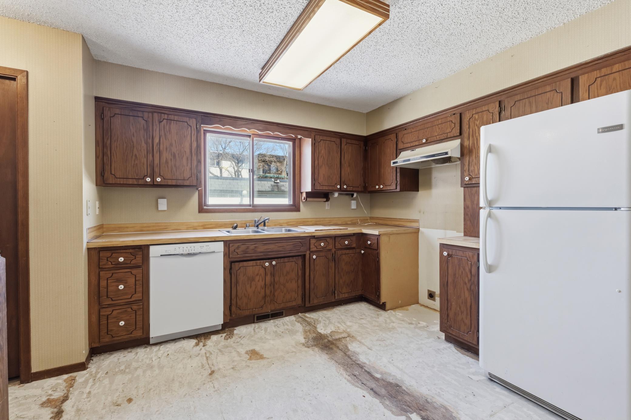 Roomy Kitchen and Dining Area, with Stairs to Lower Level just in from the Garage.