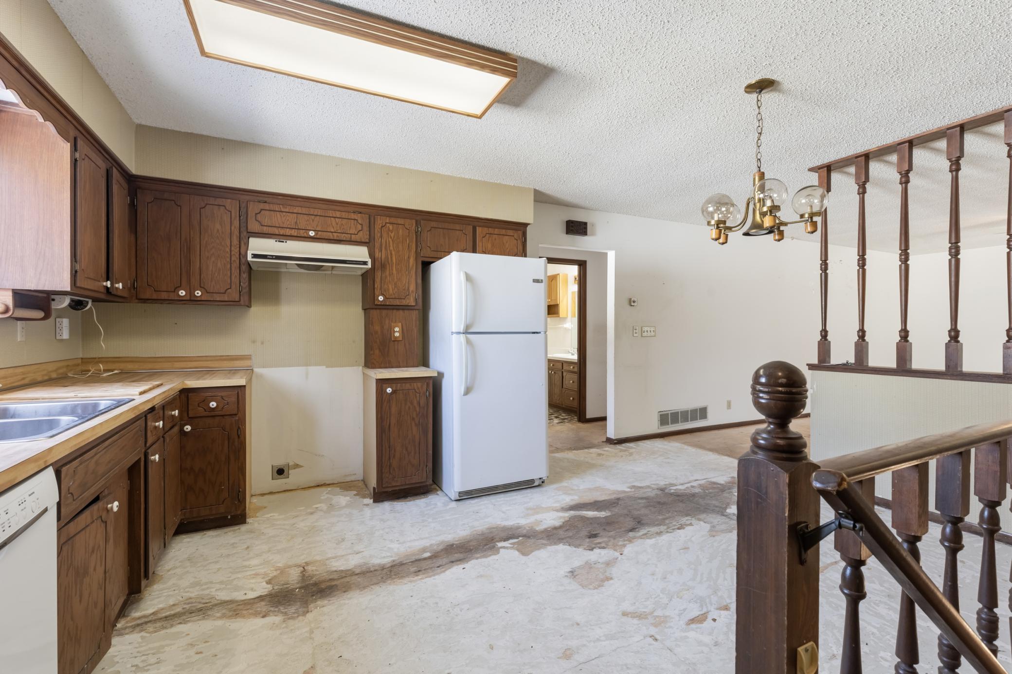Roomy Kitchen and Dining Area, with Stairs to Lower Level just in from the Garage.