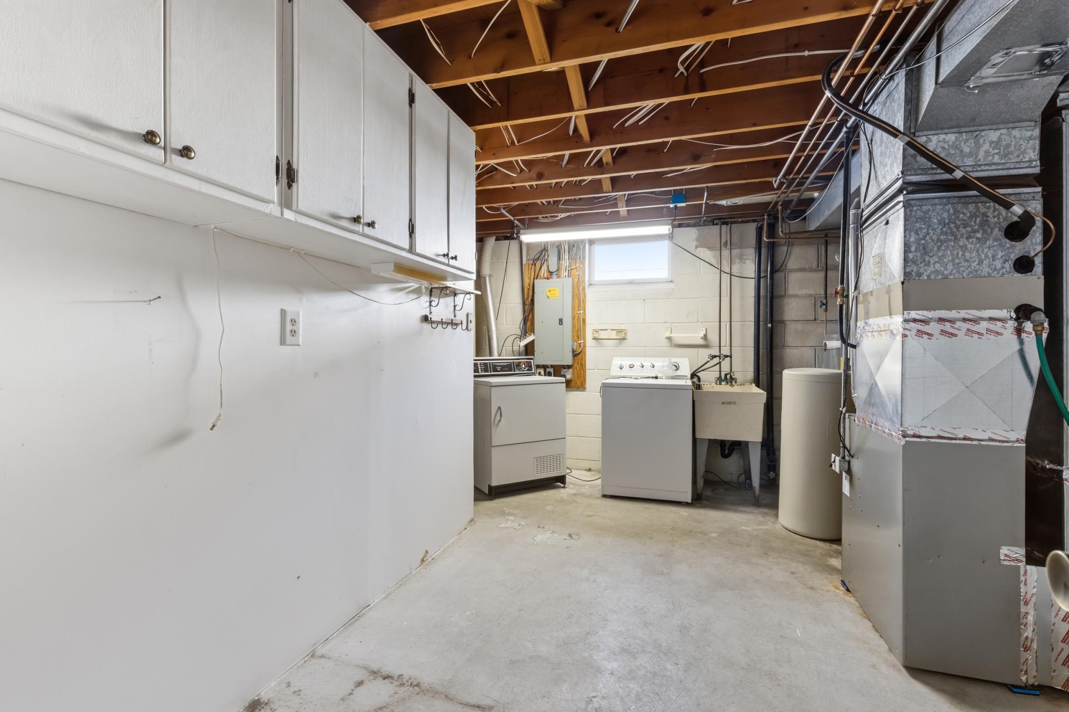 Large Utility and Storage Room. Payne Furnace (2025), Rheem Water Heater (2017), Culligan Water Softener (2013), Duct Cleaning (2026) Drain Tile and Sump Pump (1994).
