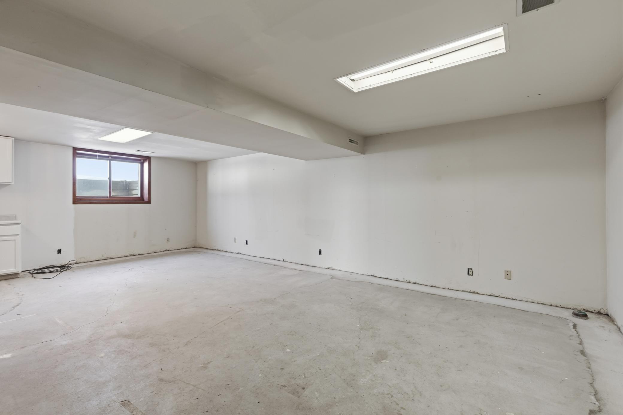 Lower Level Family Room Large Enough to Possibly Add 4th Bedroom with Modified Egress Window. Notice the Drain Tile System Leading to the Sump Pump in the Utility and Storage Room.