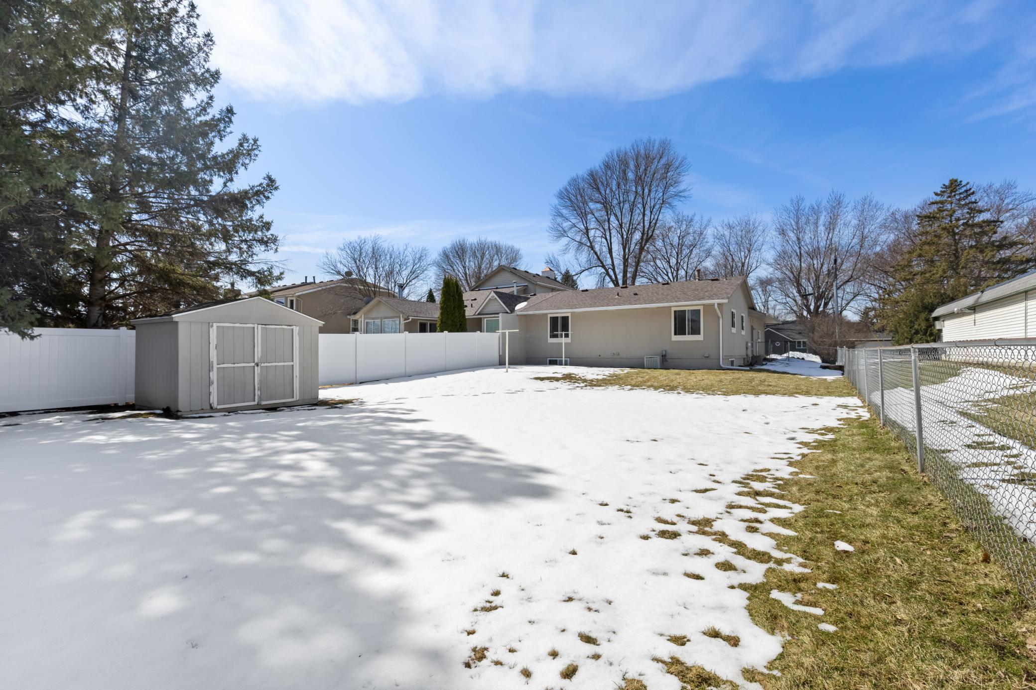 Fully Fenced Back Yard, Vinyl and Chain Link, with Gate to Garage Side Service Door and Front Yard.
