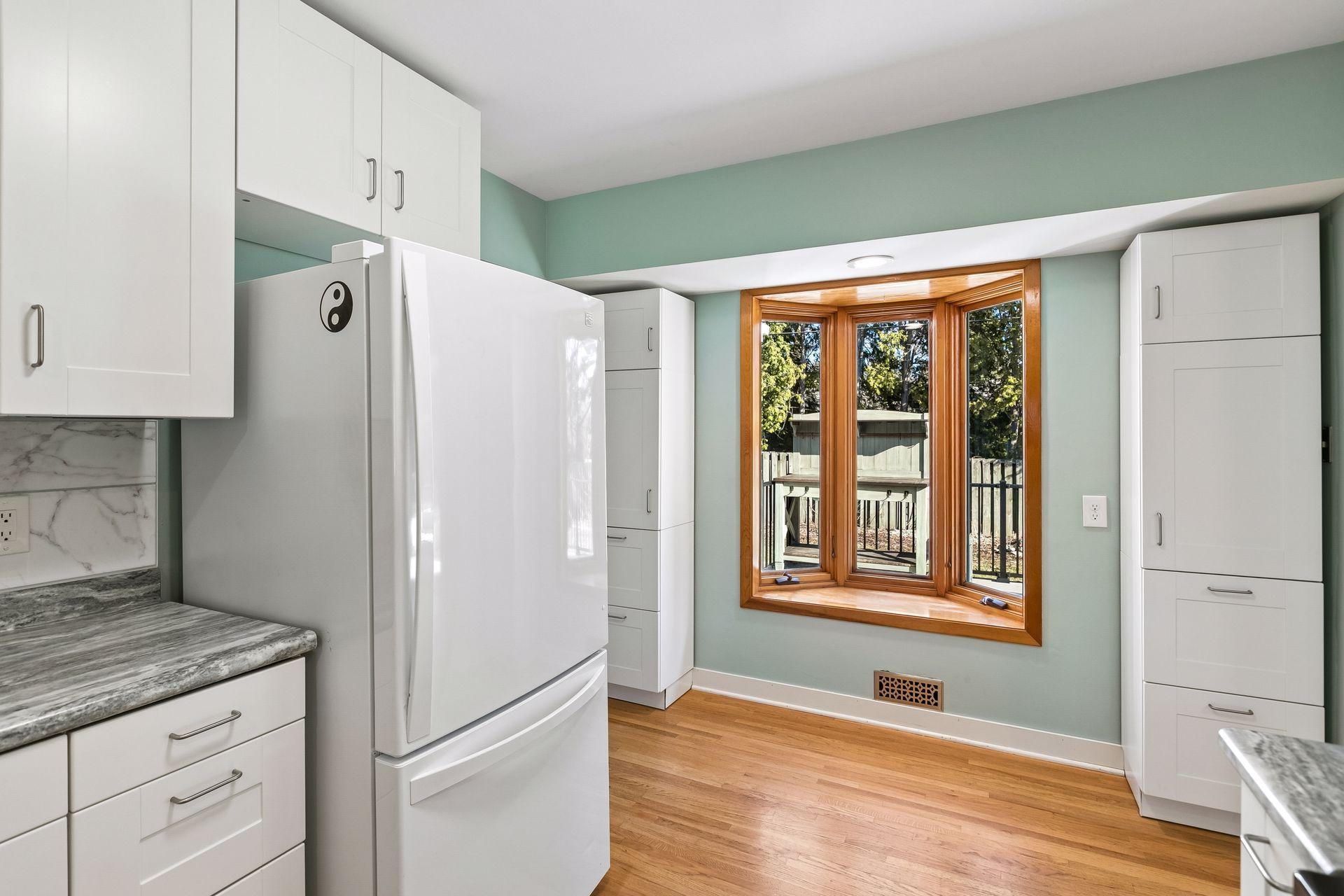 There is extra cabinetry around the bay window overlooking the backyard, creating a pantry spacce.
