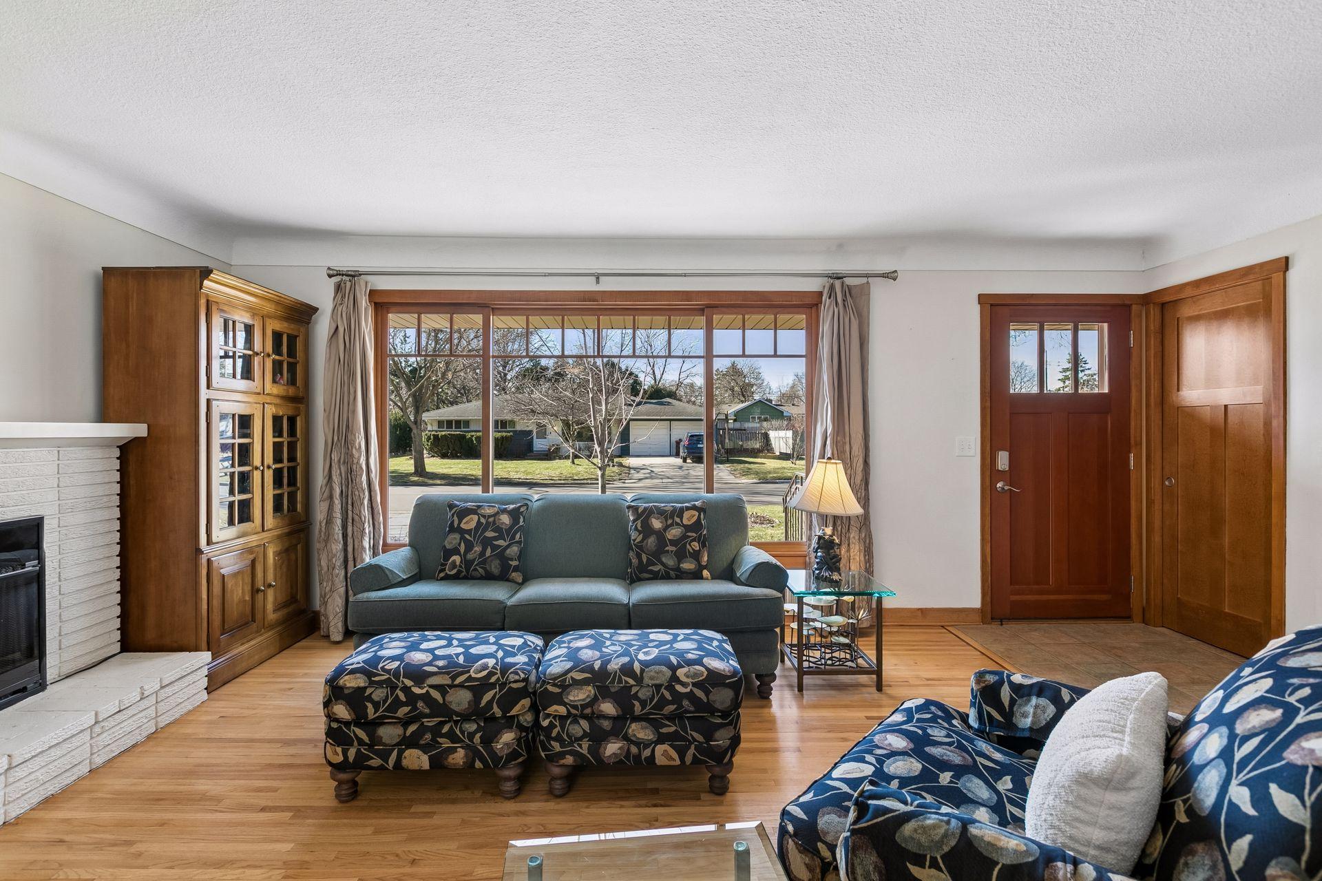 The living room features large south facing windows allowing the sunlight to pour in.